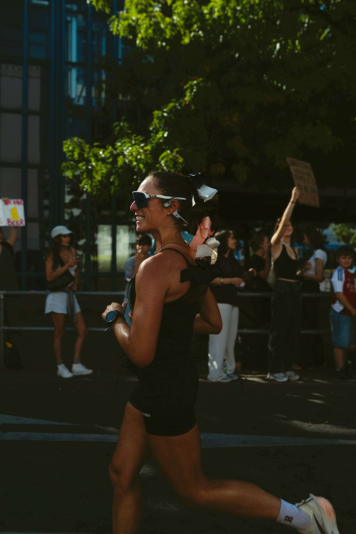 Racing the Berlin Marathon, smiling toward the crowd in Alphafly 3s, photo by Carl Nard