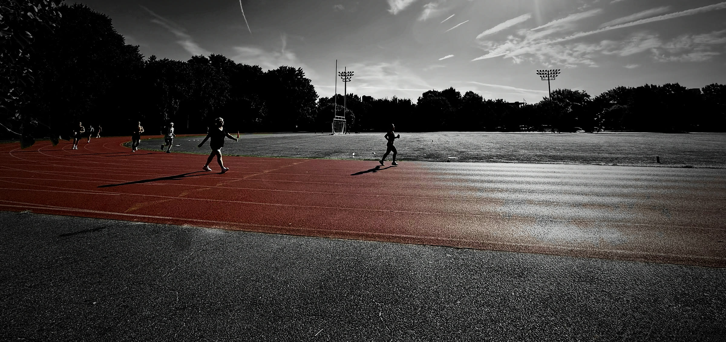 A red running track in Brooklyn in early morning sun